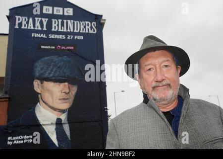 Peaky Blinders creator Steven Knight at the unveiling of a mural by artist Akse P19, of actor Cillian Murphy, as Peaky Blinders crime boss Tommy Shelby, in the historic Deritend area of Birmingham, ahead of the sixth and final series of the hit BBC One crime series. Picture date: Tuesday February 15, 2022. Stock Photo