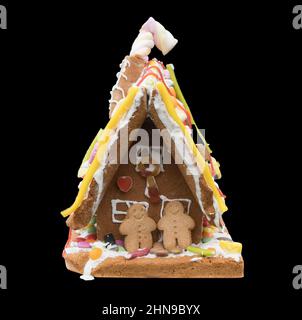 A Gingerbread house against a black background Stock Photo
