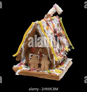 A Gingerbread house against a black background Stock Photo