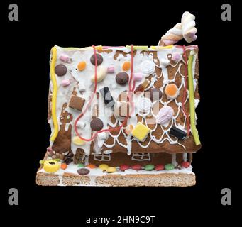 A Gingerbread house against a black background Stock Photo
