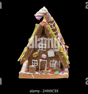 A Gingerbread house against a black background Stock Photo