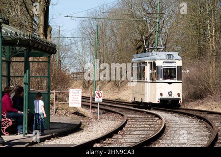 Derbyshire, UK – 5 April 2018: A vintage tram rides the tracks of the Crich Tramway Village National Tram Museum Stock Photo