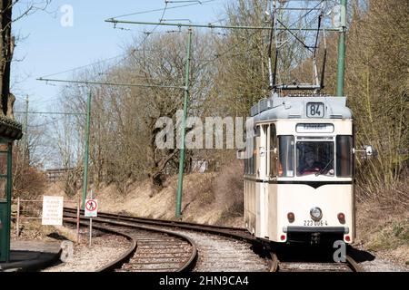 Derbyshire, UK – 5 April 2018: A vintage tram rides the tracks of the Crich Tramway Village National Tram Museum Stock Photo