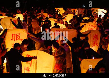 New Taipei, New Taipei, Taiwan. 15th Feb, 2022. People in preparation as lanterns are lit to colour the sky and enliven the dusk with people's wishes for luck, blessings, healthy and prosperity, during the annual Pingxi Sky Lantern Festival, in Pingxi Area of New Taipei City. Lantern Festival has been a significant convention celebrated amongst Chinese speaking regions across Asia including Taiwan, Hong Kong and Mainland China, according to the lunar calendar, with Taiwanese people releasing paper lanterns brimming with wishes and desires including safety and stability. (Credit Image: © D Stock Photo