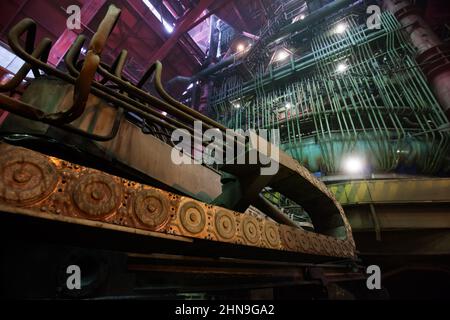 Smelter workshop. Foreground in focus. Electric arc furnace (blast furnace) on background out-of-focus. Wide-angle lens view. Stock Photo