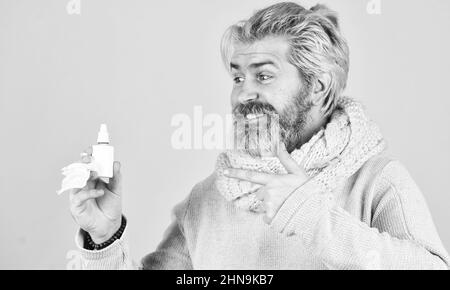 no addiction to medicals. coronavirus from china. happy hipster presenting best remedy. Nasal drops plastic bottle. pandemic concept. man treat runny Stock Photo
