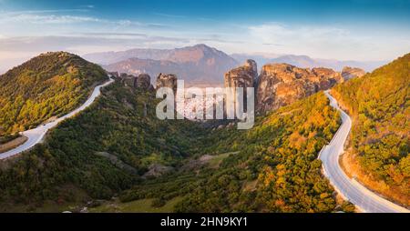 Inspirational aerial panoramic view of iconic and majestic Meteora monastery travel destination and winding road in Greece. Discover new tourist exper Stock Photo