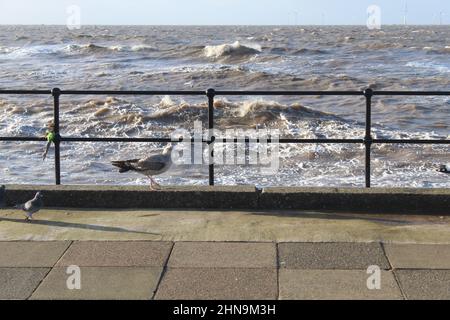 Rough sea crashing against the coast at Crosby Beach in Liverpool, Merseyside on a cold winter morning Stock Photo