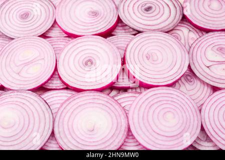Onion slices as a background. Top view. Stock Photo