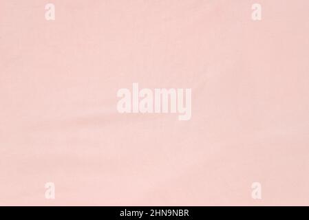 Soft smooth pink silk fabric background. Fabric texture. Stock Photo