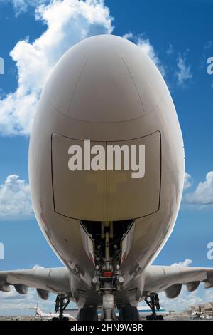 low angle view under a big jet plane parked on the tarmac Stock Photo