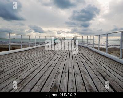 Old wooden pier on the shore of the Caspian Sea. 24 January 2020 year. Stock Photo