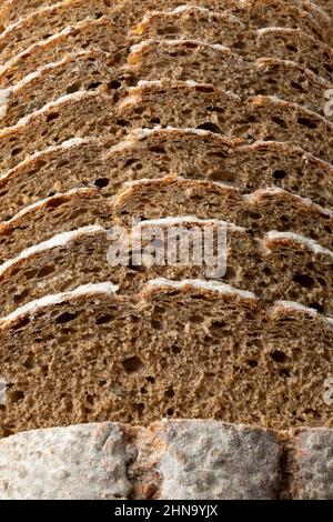 Sliced Pavé bread, multi grain bread, seen from above full frame close up as background Stock Photo