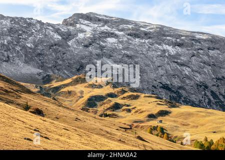 Embossed terrain on the Seiser Alm plateau and the mountain range covered with the first snow Stock Photo