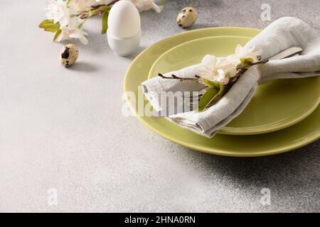 Easter festive table setting and spring decorations on gray background. Close up. Template Easter Buffet Menu. Stock Photo