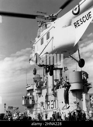 Westland WS-55 Whirlwind Har.3 Royal Navy Rescue Helicopter hovering above the landing deck of R31 HMS Warrior a Colossus class light aircraft carrier in the pacific during Operation Grapple. Stock Photo