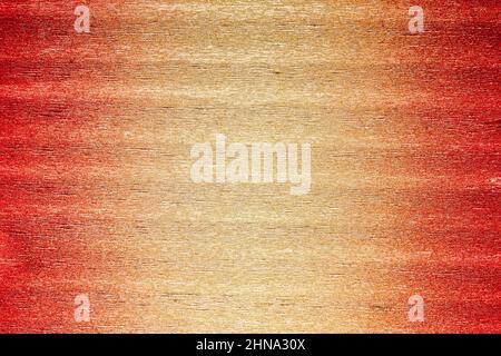 Rough texture of folded shiny metallic crepe paper or foil colored in red, orange and yellow gold gradient. Abstract background with large copy space. Stock Photo