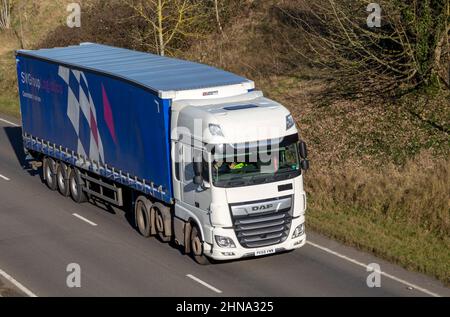 DAF HGV lorry vehicle SW Group Logistics, on A14 road, Wickham Market, Suffolk, England, UK - driver waving Stock Photo