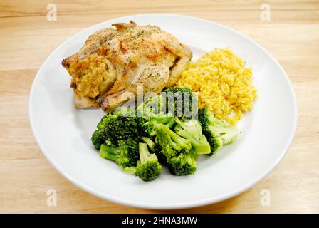 A Plated Healthy Dinner of Cornish Game Hen, Reice and Steamed Broccoli Stock Photo