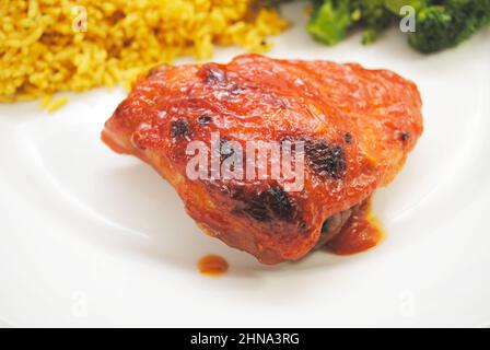 Close-Up of a Cooked Chicken Thigh with Catalina Dressing Baked on Top Stock Photo