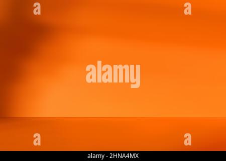 Empty orange room with deep artistic shadow. Minimalistic space concept Stock Photo