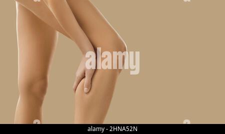 Woman suffer from pain in leg calf Stock Photo