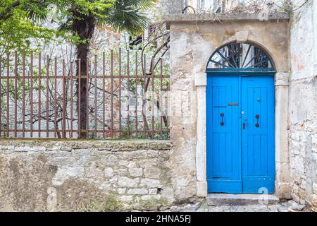 Stone facade with a blue entrance door of an old house in Rovinj, Croatia, Europe. Stock Photo