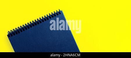 banner mockup for your text and design. empty blue notepad on yellow background Stock Photo