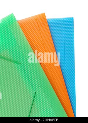 Three multi-colored folders for papers close up. Isolated on white, clipping path included Stock Photo