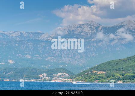 Scenic panoramic landscape view of historic town on Bay of Kotor, Montenegro with mountains at sundown. Stock Photo