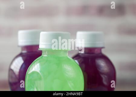 Three plastic bottles of soft drink on table  Stock Photo