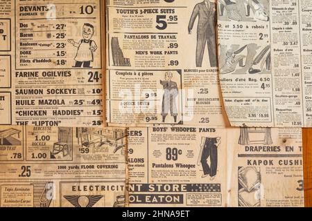 Bilingual French and English worded clothing and product advertisements printed in old newspapers from 1930s, 40s, 50s. Stock Photo