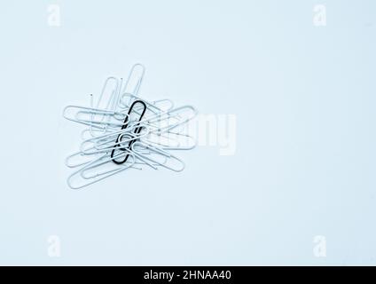Multi coloured, black and white paper clips in a pile on a plain white background. Stock Photo