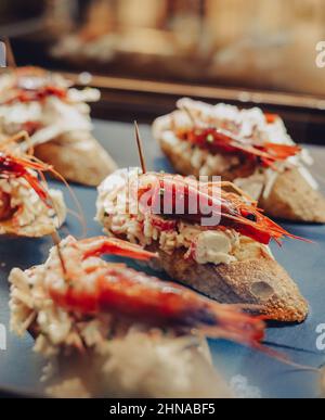 Different assorted canapes of bread with crab, ham and vegetables Stock Photo