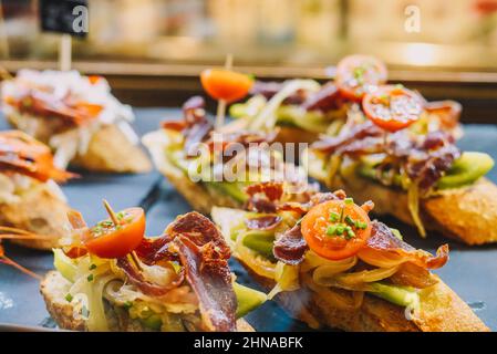 Different assorted canapes of bread with crab, ham and vegetables Stock Photo