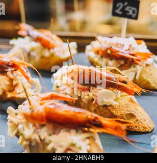 Different assorted canapes of bread with crab, ham and vegetables Stock Photo