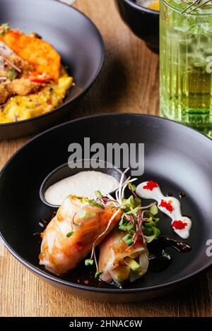 asian spring rolls with vegetables on a wooden background. resta Stock Photo