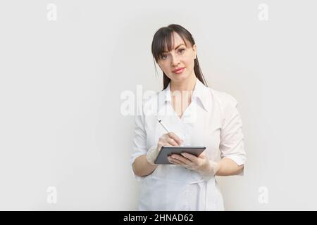 Doctor using tablet. Hospital electronic device. Online patient examination Stock Photo