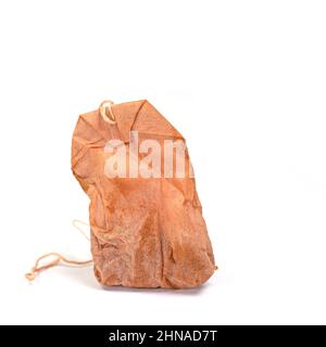 Old tea bag against white background Stock Photo