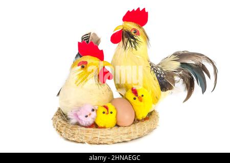 Easter composition - hen, rooster and yellow chicks in the nest isolated on white background. Stock Photo