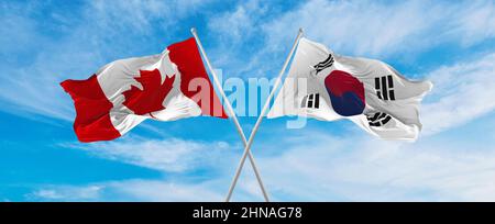 two crossed flags canada and South Africa waving in wind at cloudy sky ...