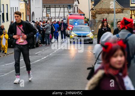Bornheim, North Rhine-Westphalia, Germany - February 22, 2020: Police car with blue lights switched on provides security during carnival parade. Stock Photo