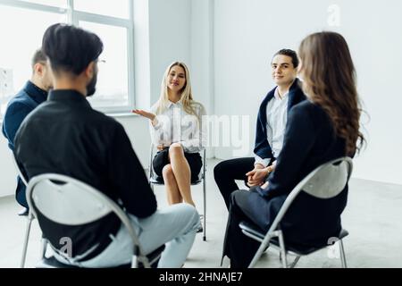 Corporate business team meeting in a modern open plan office Stock Photo