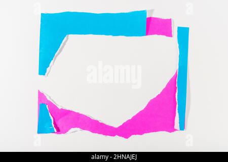 Neon blue and purple torn paper strip frame on white background. Stock Photo