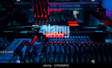 Machine Vision System inspect PCB for the number, size, and placement of components while Chip Production and SMT manufacturing. Automatic production of computer chips by SMT Pick and Place machine.  Stock Photo