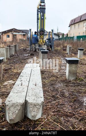 Heavy pile driving machine installing concrete foundation piles at an ...