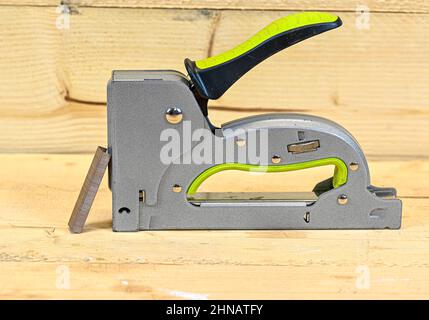 stapler and staples standing on wooden bench Stock Photo