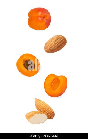 Cut apricot and almond isolated on white background with clipping path Stock Photo