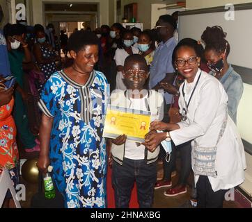 Kampala, Uganda. 15th Feb, 2022. A childhood cancer survivor (C) shows a certificate of bravery to fight against cancer during an activity to mark International Childhood Cancer Day at Mulago National Referral Hospital in Kampala, Uganda, on Feb. 15, 2022. As the world commemorates International Childhood Cancer Day on Tuesday, free treatment of children with cancer in Uganda is reigniting their hope. Credit: Nicholas Kajoba/Xinhua/Alamy Live News Stock Photo