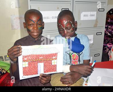 Kampala, Uganda. 15th Feb, 2022. Childhood cancer survivors show some of their drawings during an activity to mark International Childhood Cancer Day at Mulago National Referral Hospital in Kampala, Uganda, on Feb. 15, 2022. As the world commemorates International Childhood Cancer Day on Tuesday, free treatment of children with cancer in Uganda is reigniting their hope. Credit: Nicholas Kajoba/Xinhua/Alamy Live News Stock Photo